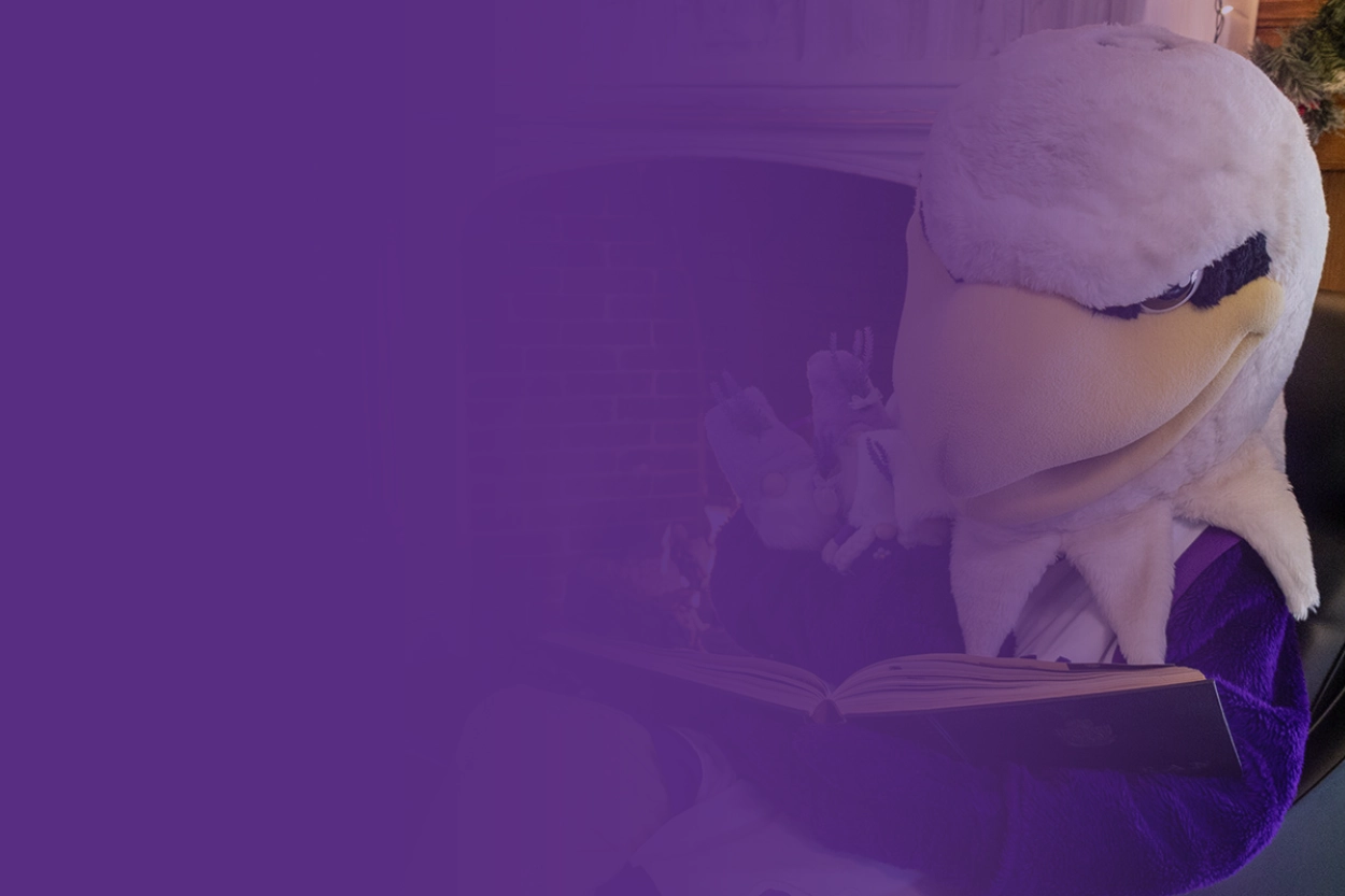 Monte reading in front of a fireplace
